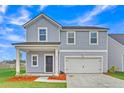 Charming two-story home featuring a covered front porch and an attached two-car garage at 141 Woodland Oak Way, Summerville, SC 29485