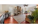 Spacious living room with a stone fireplace, ceiling fan, and French doors leading to the outdoors at 159 Bridgecreek Dr, Goose Creek, SC 29445