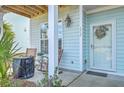 Cozy front porch with rocking chairs and a decorative wreath on the front door at 1717 Brittlebush Ln, Johns Island, SC 29455