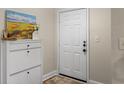 Bright entryway with a white front door, white storage cabinet, decor and a welcome mat at 1821 Chatelain Way # 1821, Mount Pleasant, SC 29464