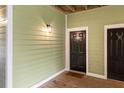 Inviting entrance to a unit featuring a black door on a green-painted wall, creating a warm and welcoming atmosphere at 1821 Chatelain Way # 1821, Mount Pleasant, SC 29464
