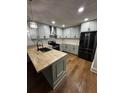 Updated kitchen features stainless steel appliances, butcher block countertop, and modern fixtures at 201 Hayden St St, Walterboro, SC 29488