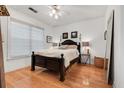Comfortable main bedroom featuring a ceiling fan, wood flooring, and a large mirror at 2244 Ashley Crossing Dr # 426, Charleston, SC 29414