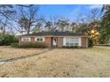 Charming single-story brick home featuring a well-manicured front lawn and cozy curb appeal at 257 Druid Rd, Charleston, SC 29407