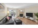 Comfortable living room featuring a fireplace, sleek black leather sofa, and a view to the outdoor balcony at 2741 Jobee Dr # 4, Charleston, SC 29414