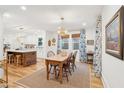 Open concept dining area with wood floors and view of kitchen at 285 Grove St, Charleston, SC 29403