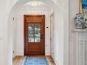 Inviting entryway with hardwood floors and view of front door with transom window at 285 Grove St, Charleston, SC 29403