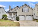 Charming home featuring a well-manicured lawn, inviting front porch, and convenient two-car garage at 366 Clayton Dr, Charleston, SC 29414