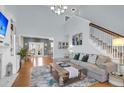 Bright living room with a large sectional sofa, wooden floors, and staircase at 366 Clayton Dr, Charleston, SC 29414