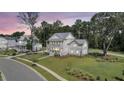 Expansive aerial view of a pristine home with lush green lawn, mature trees, and neighborhood street at 3864 Summerton St, Mount Pleasant, SC 29466