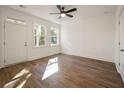 Bright bedroom with wood-look floors, a ceiling fan, and a door leading to a outdoor space at 406 Katies Scenic Ct, Charleston, SC 29492