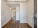 Inviting entryway with hardwood floors, wainscoting, and neutral paint creates a welcoming atmosphere at 406 Katies Scenic Ct, Charleston, SC 29492