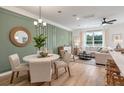 Open concept living room features a dining area, on-trend decor and a large bright sectional at 414 Duskywing Dr, Goose Creek, SC 29445