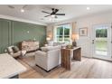 The open living room is filled with natural light and features luxury vinyl plank flooring at 414 Duskywing Dr, Goose Creek, SC 29445