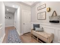 Inviting entryway with a welcome sign, a bench with decorative pillows, and light wood floors at 416 Katies Scenic Ct, Charleston, SC 29492