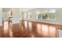 Bright and airy living room featuring gleaming hardwood floors and large windows with tree views at 498 Albemarle Rd # 306, Charleston, SC 29407