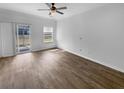 Open-concept living room with wood floors, a sliding glass door, and a large window at 510 Truman Dr, Goose Creek, SC 29445