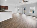 Open-concept living room and kitchen area with hardwood floors and lots of natural light at 510 Truman Dr, Goose Creek, SC 29445
