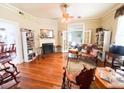 Open living room with hardwood floors, fireplace, and french doors at 715 Hampton St, Walterboro, SC 29488