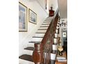 Elegant staircase features wood railing and white wainscoting at 715 Hampton St, Walterboro, SC 29488