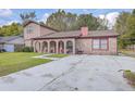Charming two-story home with red brick accents and a concrete driveway at 7791 Peppercorn Ln, North Charleston, SC 29420