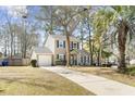 Charming two-story home at 7932 with a well-manicured front yard and a long driveway at 7932 Riverbirch Ln, North Charleston, SC 29418