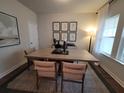 An elegant dining room featuring a natural wood table, neutral chairs, and decorative artwork at 818 Descartes St, Summerville, SC 29486