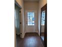 Bright entryway featuring a wood-look floor, white door, and a view to the house across the street at 818 Descartes St, Summerville, SC 29486
