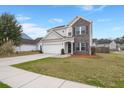 Charming two-story home with a brick and siding facade, well-manicured lawn, and a two-car attached garage at 9000 Hema Ln, Summerville, SC 29483