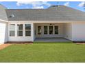 Covered back porch with ceiling fan and green lawn and a beautiful exterior at 00 N Highway 17, McClellanville, SC 29458