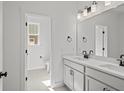 Bright bathroom features dual sink vanity, quartz countertop, modern fixtures, and tiled floors at 00 N Highway 17, McClellanville, SC 29458