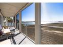Inviting screened porch with seating, offering scenic waterfront views and tranquil outdoor living at 102 Mariners Cay Dr, Folly Beach, SC 29439
