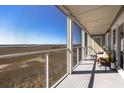 Spacious screened porch offers a serene view of the surrounding marshland and sky, perfect for relaxation at 102 Mariners Cay Dr, Folly Beach, SC 29439