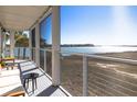 Enjoy this waterfront screened porch, equipped with comfortable seating for taking in nature's beauty at 102 Mariners Cay Dr, Folly Beach, SC 29439