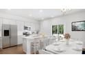 Eat-in kitchen with white cabinetry, stainless steel appliances, and a granite island at 1037 Swamp Rose Run, Summerville, SC 29485