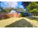 The rear exterior of this lovely home has a large backyard and a wooden fence at 1117 Oceanview Rd, Charleston, SC 29412