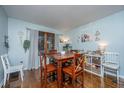 Inviting dining room with hardwood floors, a wooden table, and decor to create a cozy atmosphere at 112 Ravenswood Ct, Summerville, SC 29485