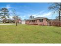 Well-maintained red brick home with a green lawn, white trim, and a welcoming front porch at 117 Swan Dr, Summerville, SC 29485