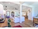 Bright living room with white shiplap walls, wood floors, and an open layout at 1174 Hitchfield Ln, Awendaw, SC 29429