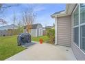 Well-manicured backyard featuring green grass, grill and storage shed at 140 Satur Dr, Goose Creek, SC 29445