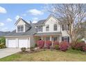 Traditional home with a two-car garage, dormer windows, and colorful landscaping at 1458 Clarendon Way, Mount Pleasant, SC 29466