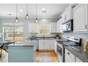 Modern kitchen with stainless steel appliances, granite countertops, and stylish pendant lighting at 1458 Clarendon Way, Mount Pleasant, SC 29466