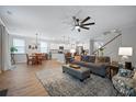 Open-concept living room and kitchen featuring hardwood floors, modern lighting, and stainless steel appliances at 146 Brant Dr, Summerville, SC 29483