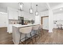 Bright, modern kitchen with white cabinets, stainless steel appliances, pendant lighting, and a center island with barstool seating at 169 Surf Bird St # 514P, Summerville, SC 29486