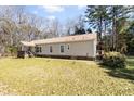 A single-story home showing its side and rear with a well-maintained lawn at 1816 Grimball Rd, Charleston, SC 29412
