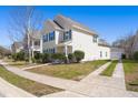 Side view of a two-story home with a driveway and green lawn at 1818 Towne St, Johns Island, SC 29455