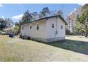 The backyard shows the house's light siding and concrete foundation at 1879 Richmond St, Charleston, SC 29407