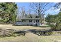 A charming single-story home with a well-manicured lawn and mature trees at 1879 Richmond St, Charleston, SC 29407