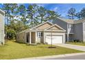 Inviting single-story home with a well-kept lawn, attached garage, and traditional architectural style at 212 Sweet Cherry Ln, Summerville, SC 29486