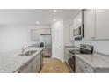 Well-lit kitchen featuring modern stainless steel appliances, granite countertops, and gray cabinets at 2254 Macallan Blvd, Ravenel, SC 29470